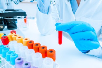 Laboratory worker with collection tubes.
