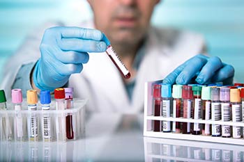 Lab worker with medical laboratory blood samples, assisting with the employee health programs at Express Lab in Boise, Garden City, Meridian, Idaho Falls, Pocatello and Rexburg.