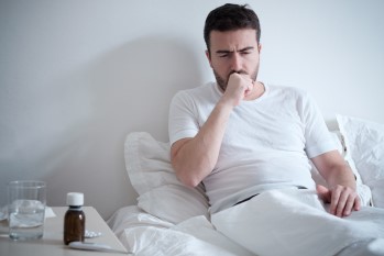 A man sick in bed.