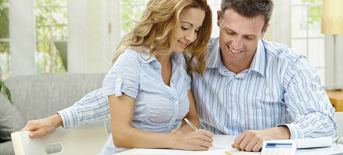 Couple reviewing finances of medical laboratory work.