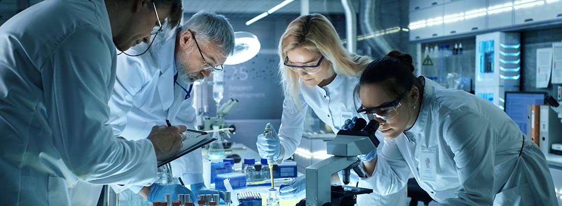 Medical laboratory workers looking through microscope. We support doctor's offices in Boise, Garden City, Meridian, Idaho Falls, Pocatello and Rexburg.