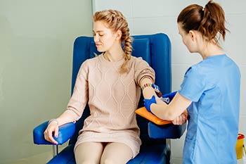 Phlebotomist taking a blood draw for a client employee at one of our medical laboratory locations in Boise, Garden City, Meridian, Idaho Falls, Pocatello and Rexburg.
